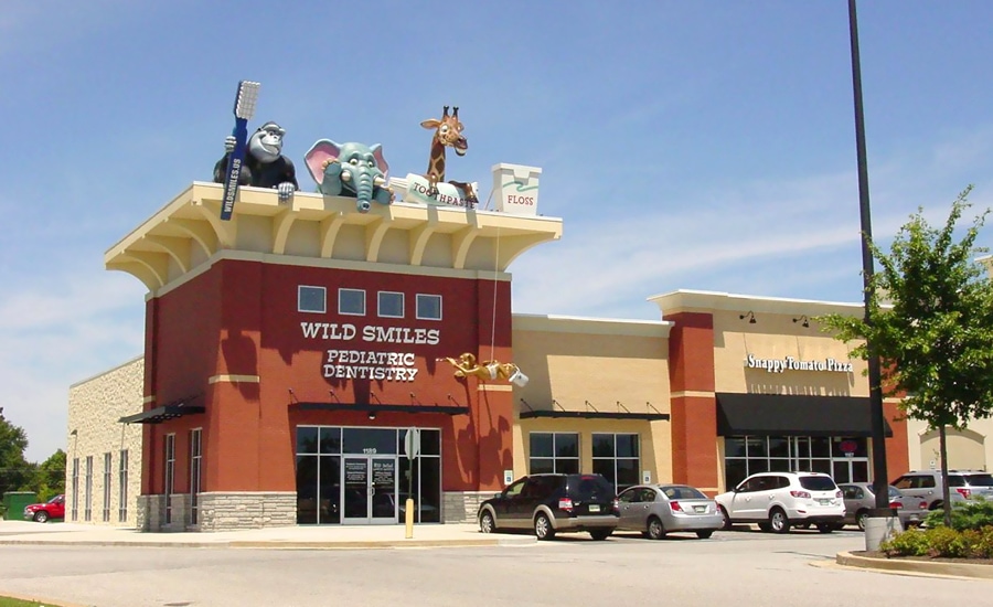 Large rooftop landmark jungle characters holding teeth-cleaning items