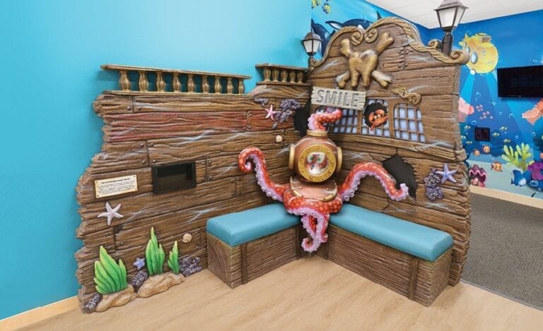 Underwater themed waiting area with sculpted shipwreck walls and octopus scuba diver character.