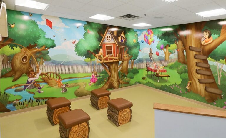 Kid's theater with backyard-themed wall murals, custom sculpted log seats
