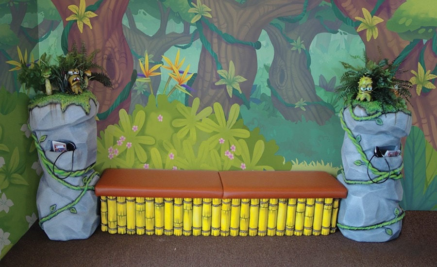 custom jungle themed bench with bamboo rocks and sugar bugs with built in game holders