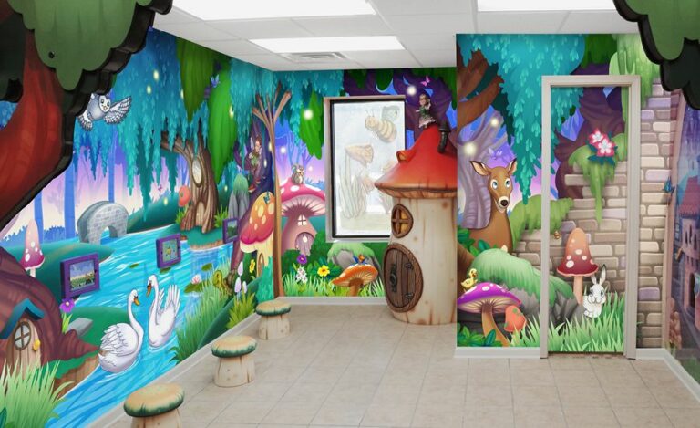Enchanted forest-themed kid's play area with colorful wall murals, mounted game pads, sculpted mushroom stool seats and decorative toadstool house.