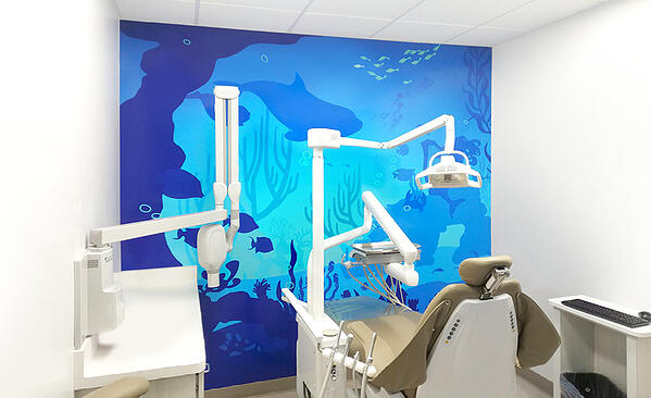 Dental treatment room with underwater silhouette mural.
