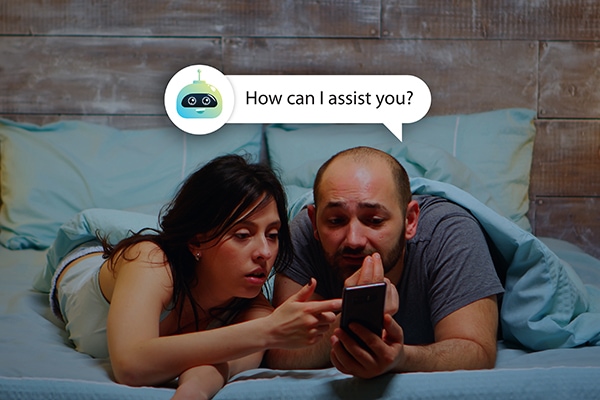 Couple interacting with virtual bot that asks "How can I assist you?" together on smartphone.