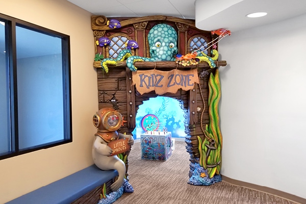 Pirate ship themed entrance to a kids zone greeted by a friendly seal and curious octopus
