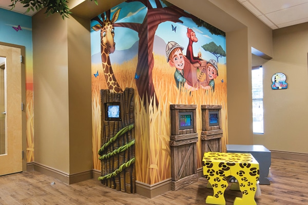 Wall mounted gaming systems in a safari themed dental office.