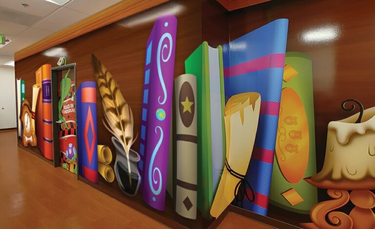 Hallway lined with mural designed to look like a giant bookcase.