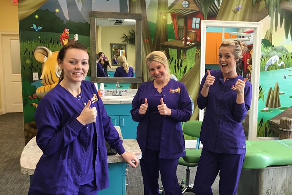 Dental staff giving thumbs up.