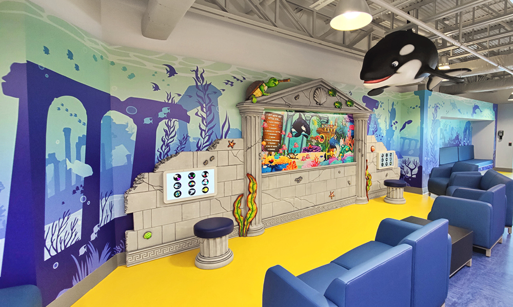 A room with a wall mural and a whale creates a creative space, perfect for brainstorming or even hiring interviews.